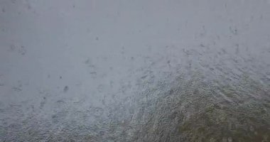 Dalgalanan yağmur damlaları yağmur mevsiminde göl yüzeyine düşer.. 