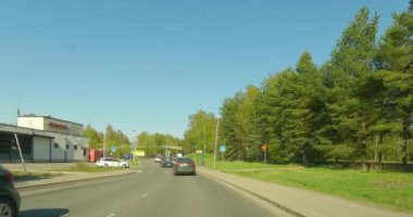 Pihlajamaki, Helsinki, Finland - 5.13.2023: POV driving on Rapakivenkaari road in clear spring weather. 