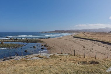 Beach landscape view near Russian border on a sunny spring day, Grense Jakobselv, Norway. clipart