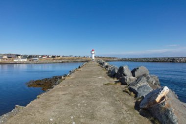 View of navigational light at the entrance to Berlevag harbor in clear summer weather, Berlevag, Norway.
