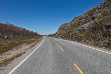 View of Ravttebelgeainu E6 road in sunny summer weather, Norway. clipart