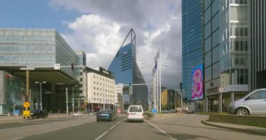 Tallinn, Estonia - July 17.2023 : POV view from car driving in Tallinn city on a asphalt road in summer with clouds in the sky.