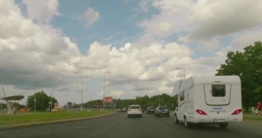 Tallinn, Estonia - July 17.2023 : POV view from car driving in Tallinn city on a asphalt road in summer with clouds in the sky.