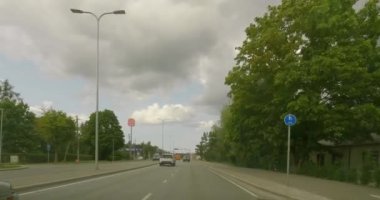 Tallinn, Estonia - July 17.2023 : POV view from car driving in Tallinn city on a asphalt road in summer with clouds in the sky.