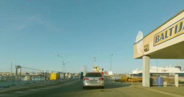 Smiltyne, Lithuania - July 13.2023: POV view from car driving  into Smiltyne car ferry at Smiltyne port to Klaipeda in summer.