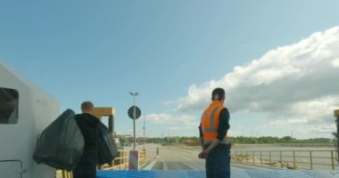 Virtsu, Estonia - July 8.2023: POV view from car driving  out off car ferry to Virtsu port in cloudy summer weather.
