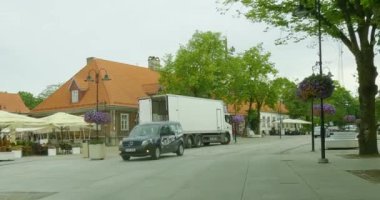 Kuressaare, Saaremaa, Estonia - July 6.2023 : POV view from car driving in Kuressaare city center on a asphalt road in cloudy summer weather.