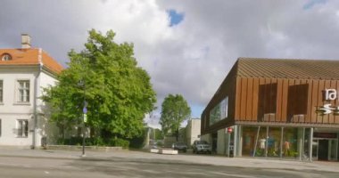 Kuressaare, Saaremaa, Estonia - July 4.2023 : POV view from car driving in Kuressaare city center on a asphalt road in cloudy summer weather.
