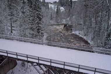 Aerial view of old Myllysilta bridge that is a museum bridge that crosses over Vantaanjoki river in winter, Myllykoski, Nurmijarvi, Finland. clipart