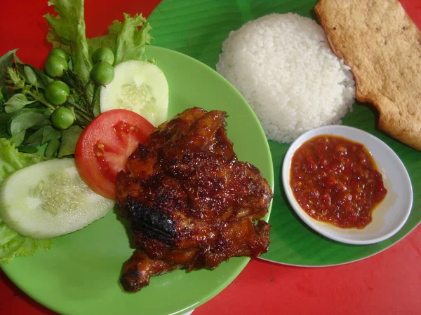 Special grilled chicken served with white rice and salad and special spicy chili sauce
