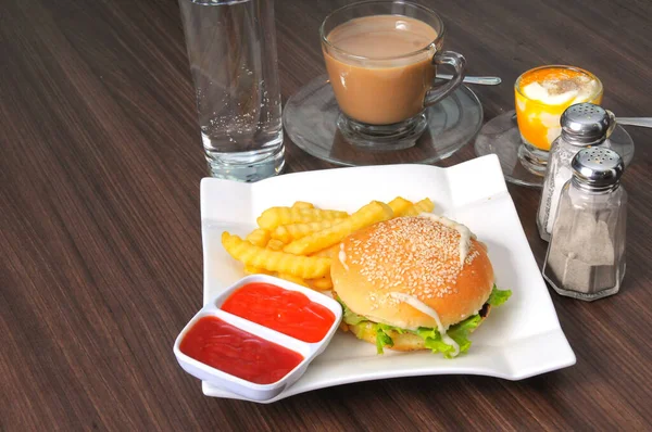 Special breakfast, meat burgers and fries served with hot milk coffee and undercooked eggs