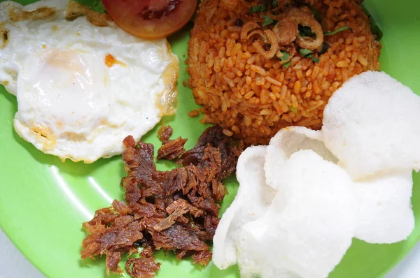 Special Fried Rice with crispy fried meat and beef eye egg as well as vegetables and crackers