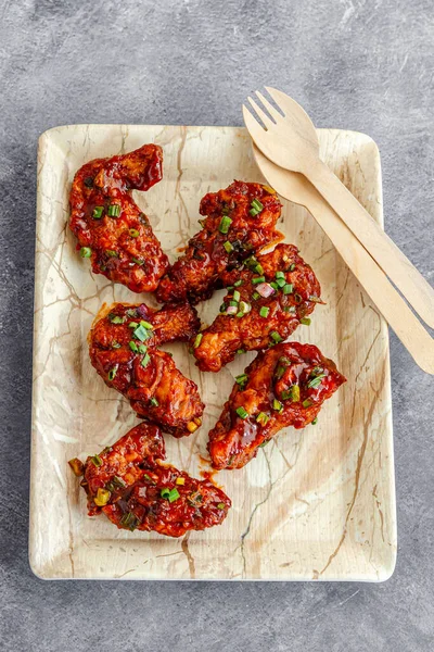 Sticky Chicken Wings Garnished with Fresh Scallion Top Down Popular Finger Food