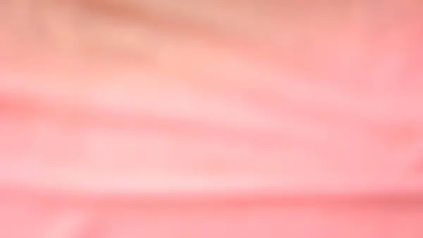 Bulanık arkaplan, pembe altın rengi, eğim ve gölgeler. Yüzey pürüzsüz ve güzel değil.