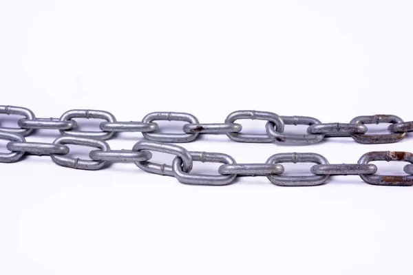 stock image A close-up of a metal chain, isolated against a white background. The chain is linked together in a series of interlocking loops.