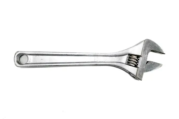 stock image An adjustable wrench, also known as an adjustable spanner, is shown in profile against a white background. The wrench has a silver metallic finish and adjustable jaws.