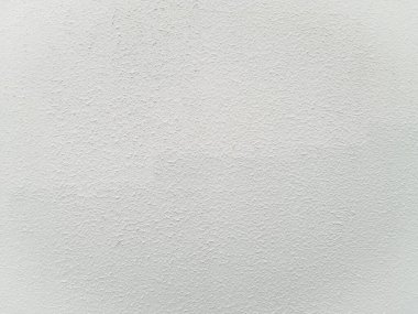 Yatay yönelimli kaba dokulu alçı bir duvarın yakın plan görüntüsü. Detaylı yüzey dokusu, tasarım projeleri için ideal, ilginç ve görsel açıdan çekici bir arkaplan yaratır..