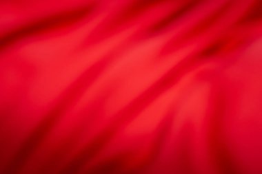 Yumuşak eğim ve akan gölgelerle dolu canlı kırmızı soyut bir arkaplan. Tasarım, reklam veya dijital sanat için ideal.