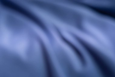 Yumuşak, bulanık mavi bir arka plan. Nazik kıvrımlar ve gölgeler, rahatlatıcı ve zarif bir görsel etki yaratıyor. Tasarım veya sunum kullanımı için mükemmel.