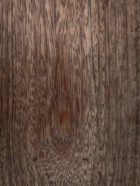 Detaylı tahıl desenleri ve sıcak kahverengi tonlarıyla doğal ahşap dokunun yakın çekimi. Tasarım projelerinde arka plan için ideal.