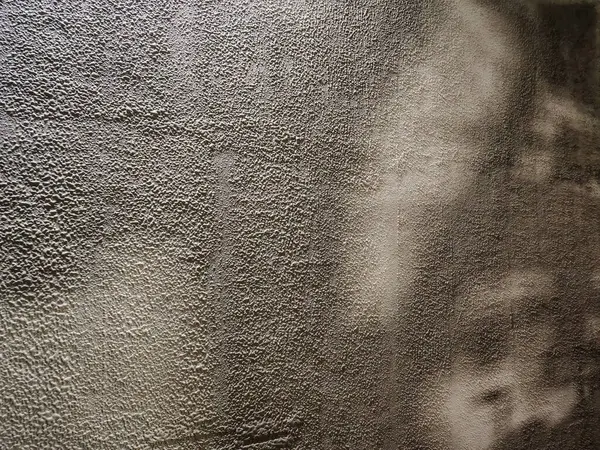 Kabataslak duvar dokusuna yakın çekim, çakıllı kaplama ve doğal ışık gölgeleri. Soyut arkaplan, tasarım veya mimari referans için ideal.