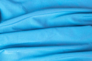 Arkaplan ve tasarım için açık mavi kumaş dokusu, güzel buruşuk ipek ya da keten deseni.