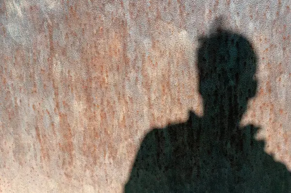 rusty sheet metal with the shadow of a man