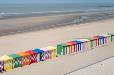 Colorful changing cabins on the beach clipart