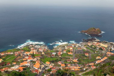 A breathtaking view of Porto Moniz, Madeira, showcasing the iconic natural swimming pools surrounded by the Atlantic Ocean and the charming coastal town clipart