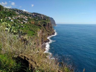 View of the cliffs of Madeira near the town of Ribeira Brava (Madeira, Portugal) clipart