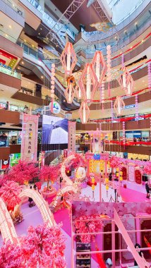 Penang Malezya 15 Ocak 2024: Bir alışveriş merkezi koridorunda Çin Yeni Yıl Şenlikleri. Tavandan sarkan fenerler. Gurney Plaza Alışveriş Merkezi. Pembe ejderha ve kiraz ağaçları.
