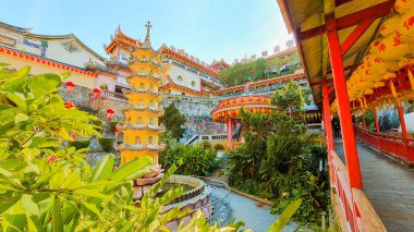 Penang Jan 11 2024: Pagoda ve Pavilion Kek Lok Si Tapınağı avlusunda. Süslü detaylarla geleneksel Çin mimarisi. Renkli fenerler. Güzel bahçe düzenlemesi.