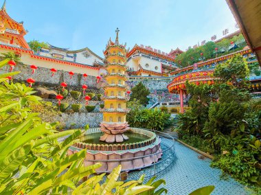 Penang Jan 11 2024: Pagoda ve Pavilion Kek Lok Si Tapınağı avlusunda. Süslü detaylarla geleneksel Çin mimarisi. Renkli fenerler. Güzel bahçe düzenlemesi.