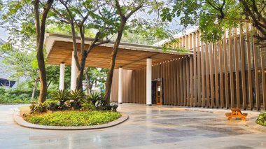 Cakarta Endonezya 22 Ağustos 2023: Büyük bir tepe örtüsü ve bereketli peyzaj, büyük ağaçlar ve parlak güneşli gökyüzü ile parlayan bir fayans yolu ile ahşap ikincil deri cepheli bir bina