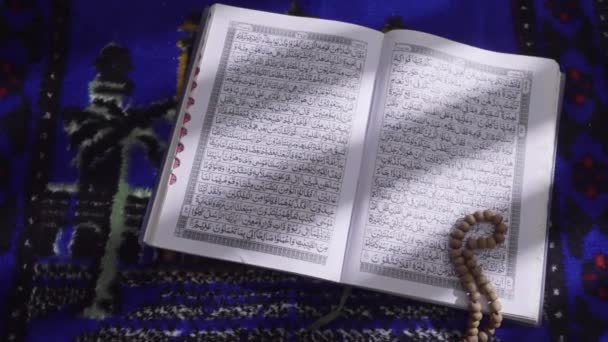Wooden Prayer Beads Lay Pages Open Quran Illuminated Light Streaming — Stock Video