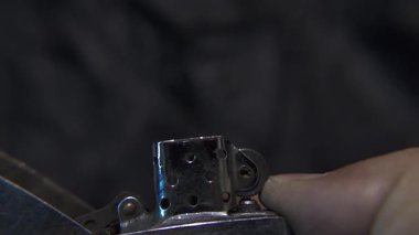 Çakmağın kıvılcımları ve alevi. Metal bir çakmağın yakın çekimi bir alev patlaması ve canlı uçan kıvılcımlar.