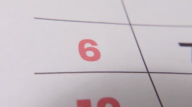 Önemli bir hatırlatma veya planlanmış olayı vurgulayan koyu kırmızı haç işaretli bir takvimdeki 6 numaralı tarihi vurgula.