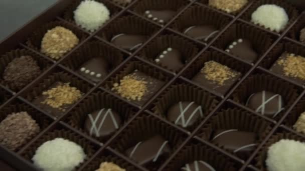 Close Slow Motion Dolly Shot Selection Chocolates Package — Stock Video