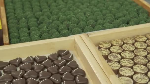 Dolly Medium Slow Motion Shot Assorted Chocolate Candy Wooden Boxes — Stock Video