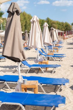 Beach Umbrellas and blue beach beds on a sandy beach.