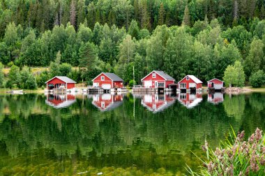 Red houses at sunset on a lake, Hga Kusten, Sweden clipart