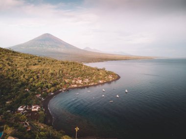 Drone view in the morning at Amed towards Mount Agung Volcano clipart