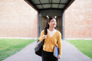 Elementary school student walking down a bright school hallway, heading back to class after enjoying recess, carrying a backpack and embracing the joy of learning.