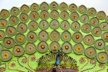 Colorful Decorative Plates with Peacock Motifs on Green Backdrop