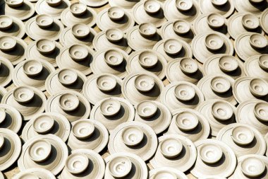 Close-Up of Uniform Clay Pottery Pieces Arranged in Sunlight