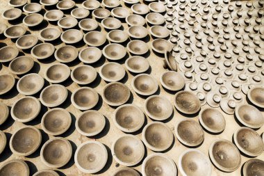 Close-Up of Uniform Clay Pottery Pieces Arranged in Sunlight