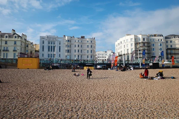 İnsanların oturduğu ve üzerinde yürüdüğü bir kumsal.