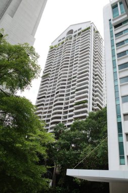 Önünde saat olan yüksek bir bina.