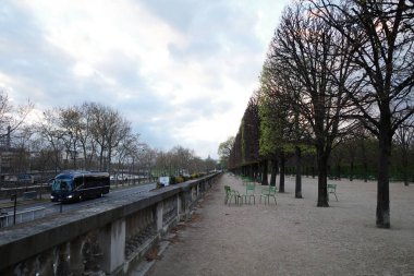 Bir parkın yanındaki yolda giden bir araba.