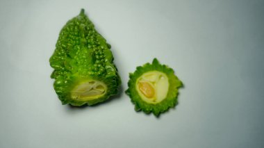 Fresh bitter melon on white. Healthy bitter melon for human body.